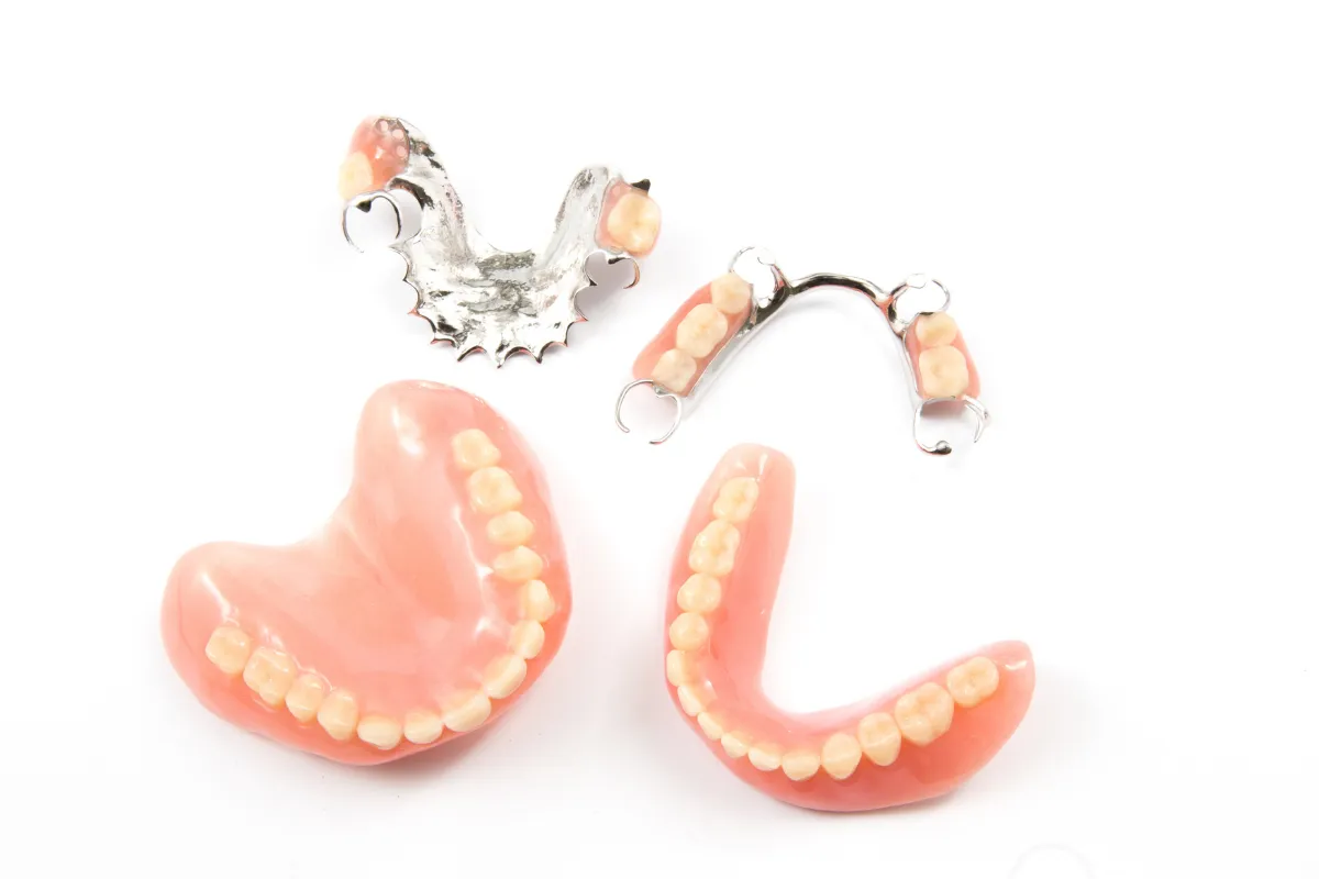 A woman smiling confidently with snap-on dentures.