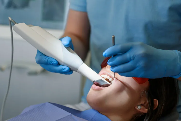 Dentist using an intraoral camera to scan a patient's mouth at Dorri's Dental in Boynton Beach, FL