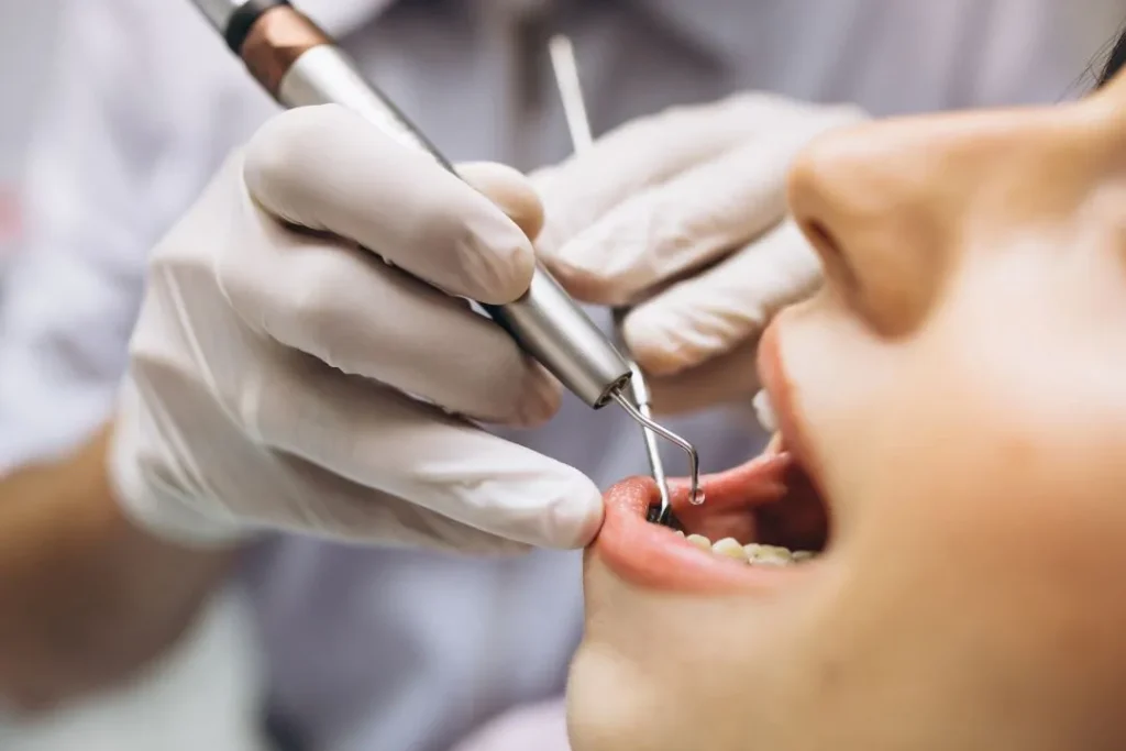 Dentist examining a patient before fitting complete dentures at Dorri's Dental in Boynton Beach, FL
