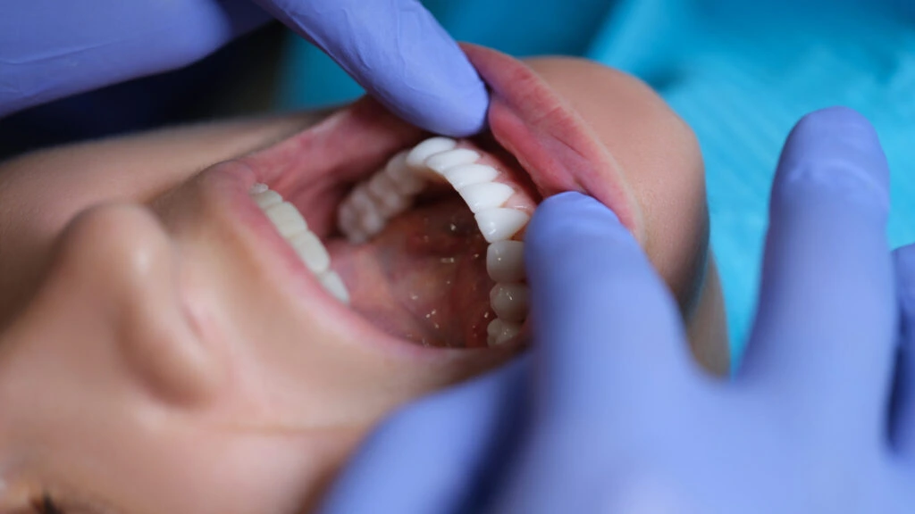 Dentist performing a comprehensive oral exam on a patient at Dorri's Dental in Boynton Beach, FL