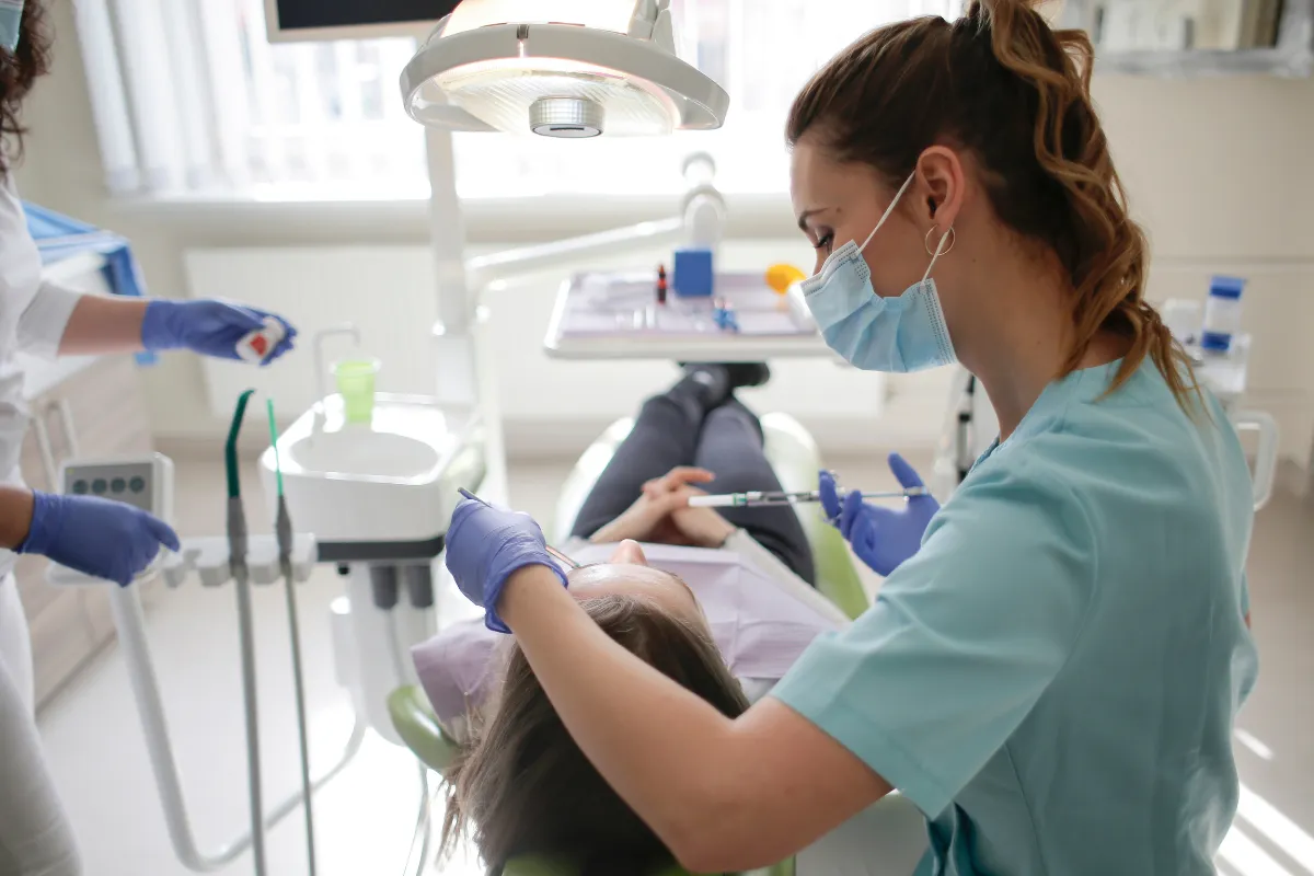 Dental professional examining a patient's teeth