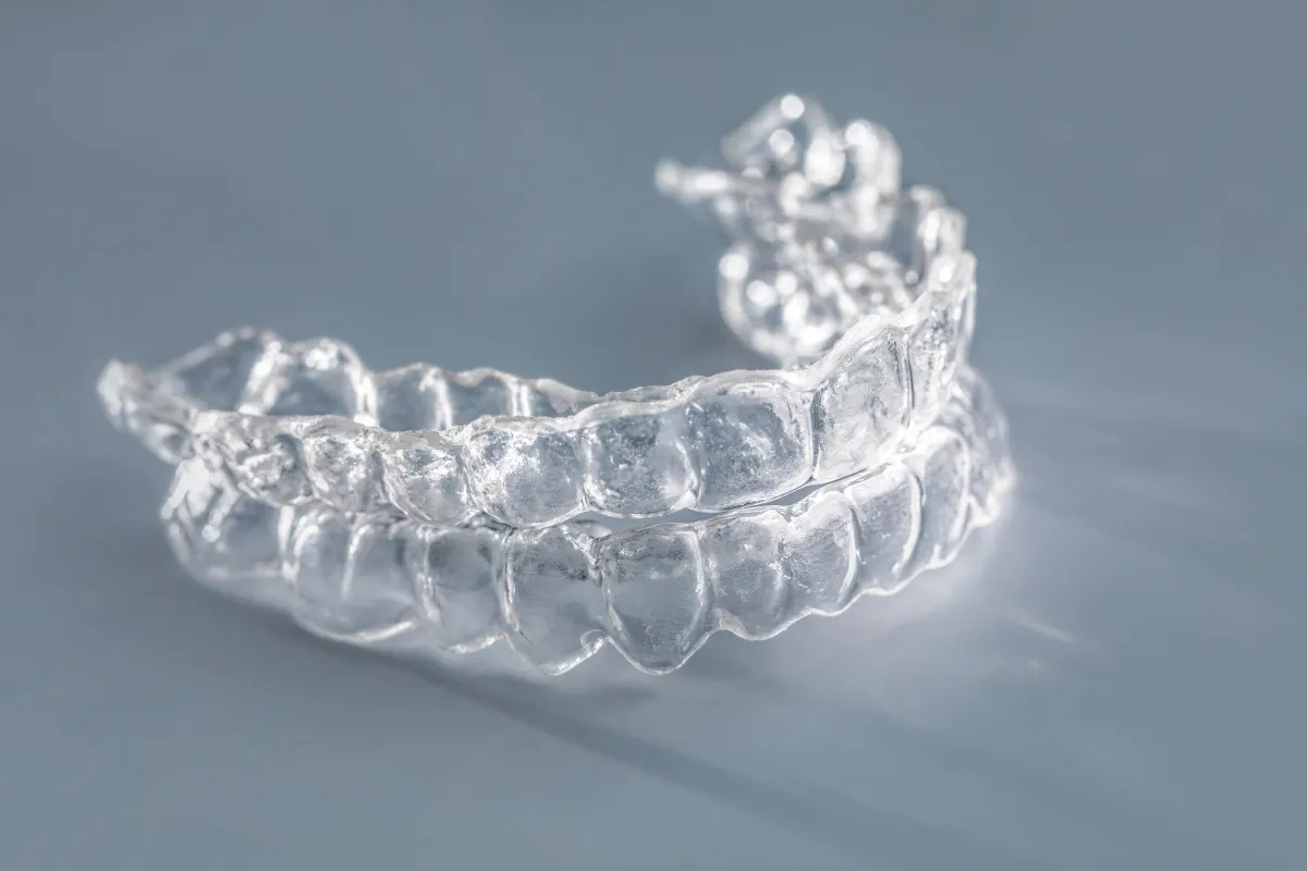 Smiling woman with clear aligners