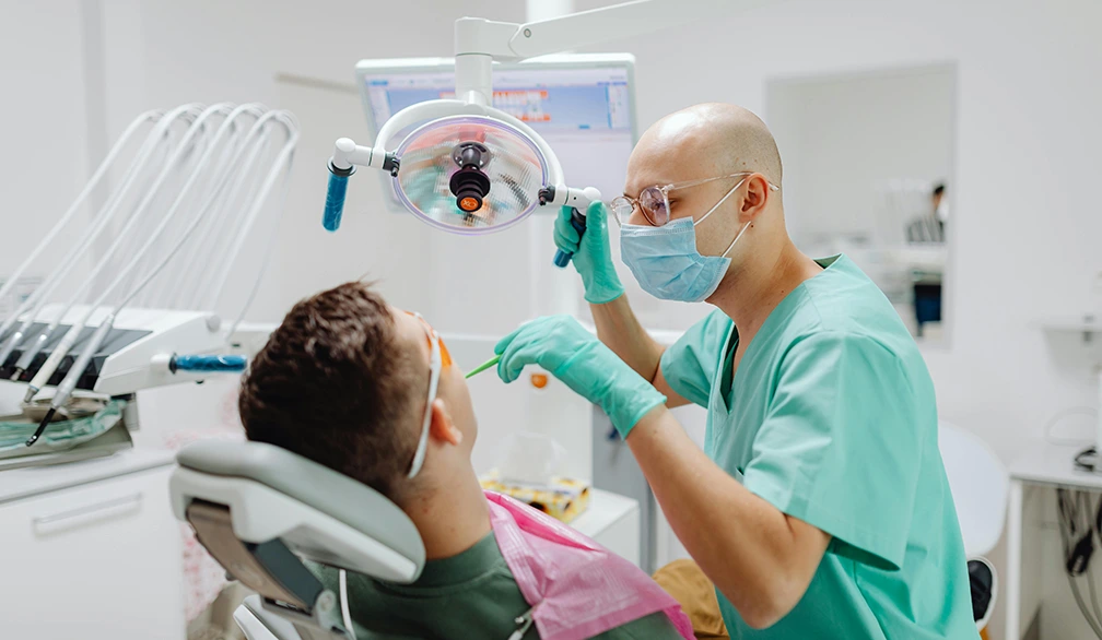 Dentist performing a dental exam on a patient in Boynton Beach